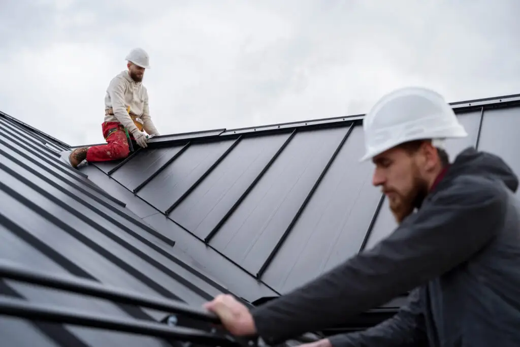 Roof replacement crew installing metal roofing Bossier City LA - NELA Roofing